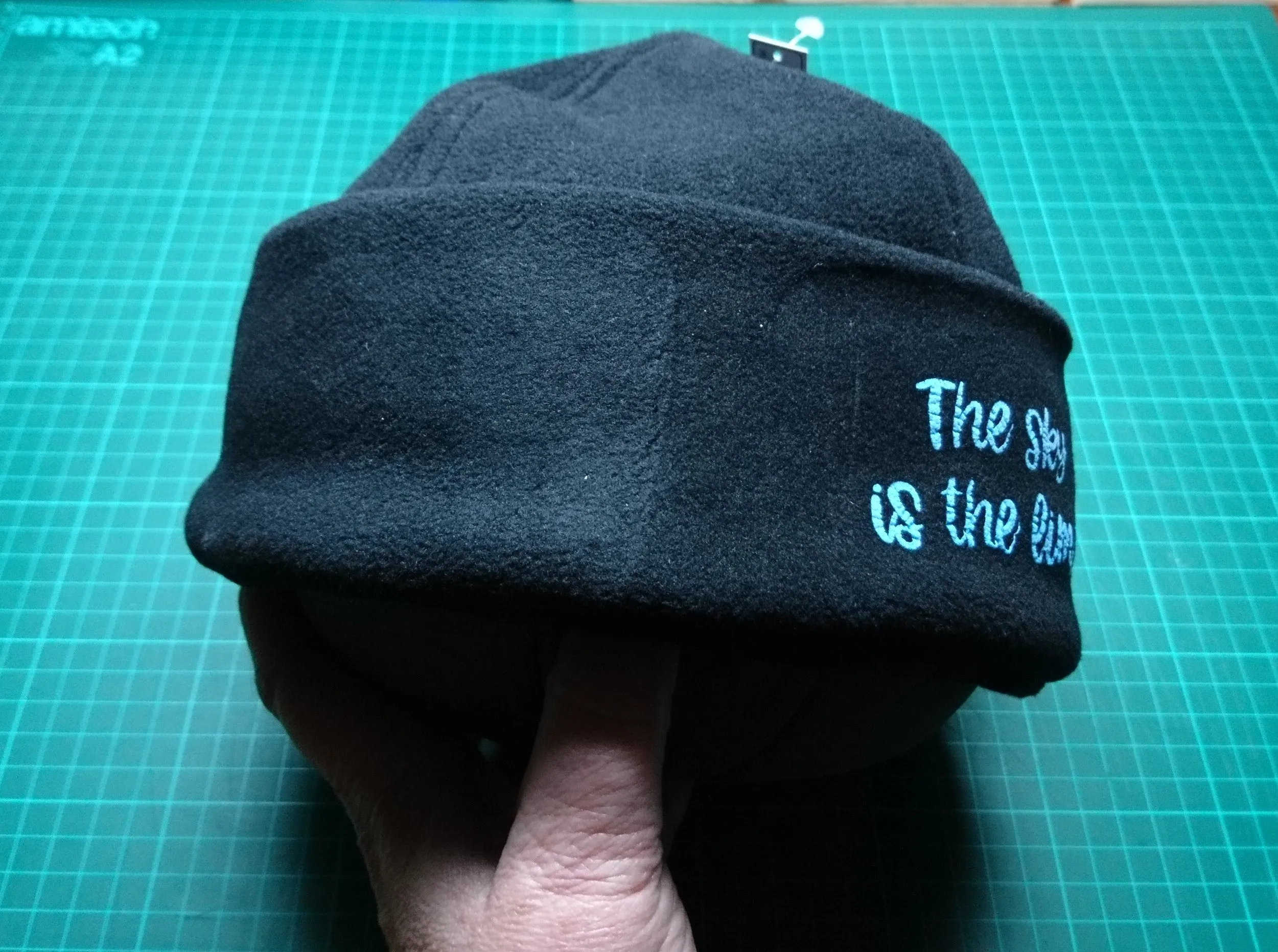 3D- Puff Glow in The Dark. Green Neon Vinyl on Black Supra Fleece Ski Hat with the quote "The Sky is the Limit". Comfy, Warm, Sport. One Size.