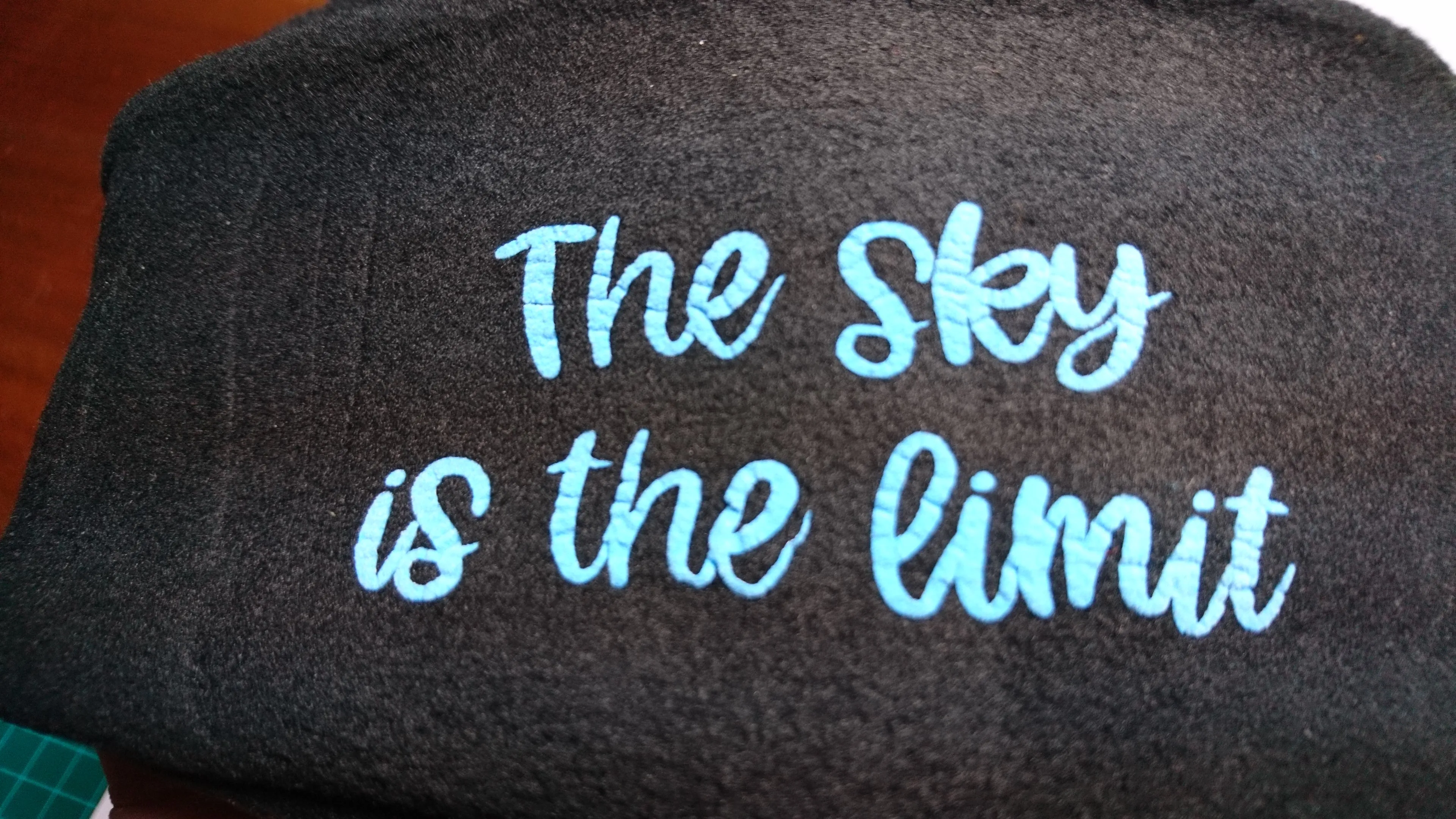 3D- Puff Glow in The Dark. Green Neon Vinyl on Black Supra Fleece Ski Hat with the quote "The Sky is the Limit". Comfy, Warm, Sport. One Size.